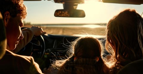 Family road trip at sunset